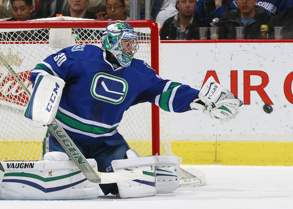 VANCOUVER, BC - JANUARY 27:   Ryan Miller #30 of the Vancouver Canucks plays the puck against the Anaheim Ducks during their NHL game at Rogers Arena January 27, 2015 in Vancouver, British Columbia, Canada.  (Photo by Jeff Vinnick/NHLI via Getty Images)