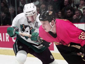 Bobby Dollas sports the traditional Mighty Ducks look against Canucks legend Alex Mogilny.