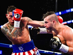 NEW YORK, NY - DECEMBER 06:  Gabriel Rosado (L) throws a punch at David Lemieux during a NABF Middleweight title fight at the Barclays Center on December 6, 2014 in the Brooklyn Borough of New York City.  (Photo by Alex Goodlett/Getty Images)