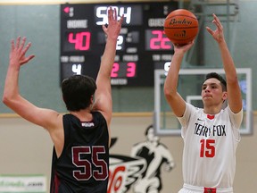 Terry Fox's Gabe Laza attempts a three-point shot against a Cowichan defender in the Ravens' 79-52 win over the Thunderbirds at the 2015 Legal Beagle Thursday in PoCo. (Photo by Ron Hole for ronhole.com)