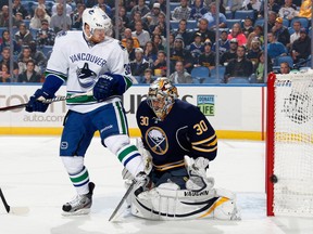 Jannik Hansen of the Canucks screens Ryan Miller of the Sabres in an Oct. 17, 2013 game in Buffalo.  (Photo by Jen Fuller/Getty Images)