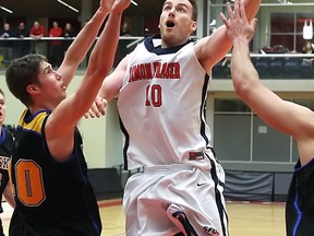 Simon Fraser Clan's Michael Harper drives the lane against Alaska Fairbanks' defender Ruben Silvas on Thursday in GNAC action on the hill (Ron Hole, SFU athletics)