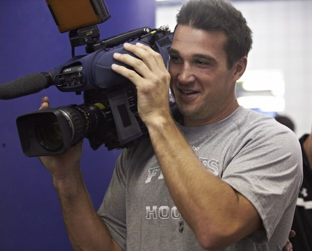 Calgary Flames' Shane O'Brien tries out a TV camera during a training camp fitness test in Calgary, Alta., Wednesday, Sept. 11, 2013.THE CANADIAN PRESS/Jeff McIntosh ORG XMIT: JMC105