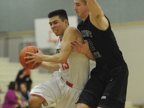Terry Fox Ravens' senior Liam Hancock (left) drives by Langley's Walnut Grove Gators during 79-69 win Saturday in Port Coquitlam. (Jason Payne, PNG photo)