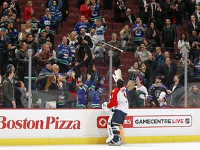 Roberto Luongo goes old school and tosses his stick into the crowd after being named the first star Thursday. (Photo by Jeff Vinnick/NHLI via Getty Images)