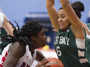 WJ Mouat's Penielle M'Bakata (left) drives on Oak Bay's Jahniaa Thomas on Friday at the Top 10 in Coquitlam. (PNG photo)