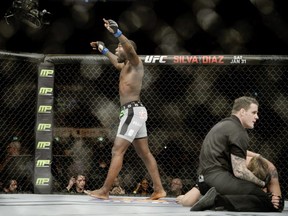 Anthony "Rumble" Johnson, left, celebrates winning against Alexander "The Mauler" Gustafsson, right, in their UFC featherweight mixed martial arts bout in Stockholm (AP Photo/TT, Jessica Gow)