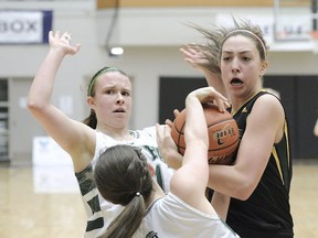 Doing her thing, Argyle's Sophie Swant (right) battled Marisa Harrington (left) and Morgan Roskelley at the 2014 B.C. Girls Triple A basketball championships. (PNG file photo)