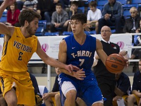 UBC Thunderbirds’ fifth-year senior forward Tommy Nixon (right), guarded earlier this season by Victoria’s Mack Roth, has almost doubled his career scoring average this season to 19 points per game. (Richard Lam, UBC athletics)