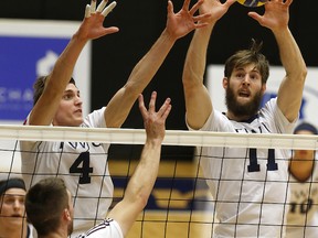 Trinity Western Spartans’ Blake Scheerhoorn (left) and Danny Grant were part of a brick-wall defence for the nation’s No. 3-ranked volleyball team, which swept Edmonton’s visiting MacEwan Griffins by identical 3-0 scores in Canada West action Friday and Saturday at the Langley Events Centre. This week, TWU plays at host UBC. (Scott Stewart, TWU athletics)