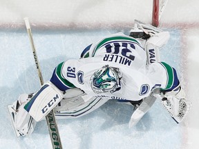 ST. PAUL, MN - FEBRUARY 9: Kyle Brodziak #21 of the Minnesota Wild scores a goal against Ryan Miller #30 of the Vancouver Canucks during the game on February 9, 2015 at the Xcel Energy Center in St. Paul, Minnesota. (Photo by Bruce Kluckhohn/NHLI via Getty Images)