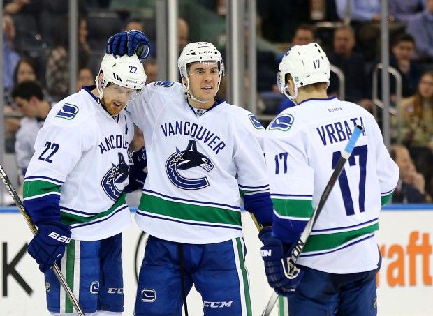 NEW YORK, NY - FEBRUARY 19:  Adam Clendening #44 celebrates with Daniel Sedin #22 and Radim Vrbata #17 of the Vancouver Canucks after a goal in the third period against the New York Rangers on February 19, 2015 at Madison Square Garden in New York City.The Vancouver Canucks defeated the New York Rangers 5-4 in an overtime shootout.  (Photo by Elsa/Getty Images)