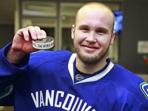 A picture is worth 1,000 words. Alex Biega poses with puck after scoring game-winning goal in his first NHL game Monday after being recalled from the Utica Comets. (Getty Images via National Hockey League).