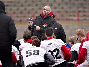 Blake Nill speaks to his charges in preparation for the 2013 Vanier Cup, when he coached the Calgary Dinos.