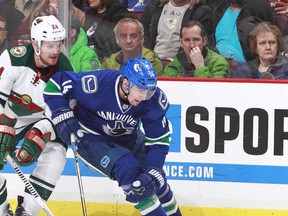 VANCOUVER, BC - FEBRUARY 28: Matt Cooke #24 of the Minnesota Wild and Alexandre Burrows #14 of the Vancouver Canucks battle for the puck during their NHL game at Rogers Arena February 28, 2014 in Vancouver, British Columbia, Canada.  Minnesota won 2-1 in a shootout. (Photo by Jeff Vinnick/NHLI via Getty Images)