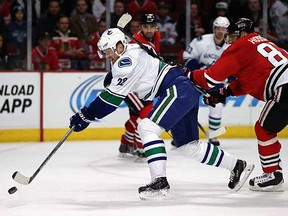 Daniel Sedin scores the overtime winner Wednesday night against the Blackhawks.