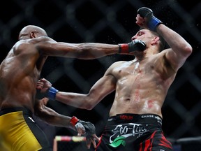 Middleweight Anderson Silva and Nick Diaz trade punches late in their fight at the MGM Grand Garden Arena in Las Vegas on Saturday, Jan. 31, 2015. (AP Photo/Las Vegas Sun/LE Baskow)