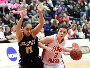Simon Fraser senior guard Erin Chambers (right), driving past Alaksa Fairbanks’ Victoria Elleby, scored a game-high 25 points Saturday as the Clan topped visiting the Nanooks  in its final home game of the season. (Ron Hole, SFU athletics)