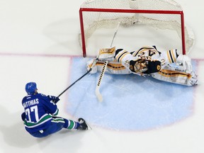 Shawn Matthias of the Vancouver Canucks sweeps around Tuukka Rask of the Boston Bruins to score a goal during their February 13, 2015 in Vancouver.  (Photo by Jeff Vinnick/NHLI via Getty Images)