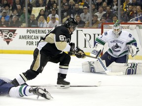 Sidney Crosby of the Pittsburgh Penguins takes a shot on Eddie Lack of the Vancouver Canucks during Vancouver's 3-0 win in Pittsburgh on Dec. 4. Pittsburgh is in Vancouver tonight, but Ryan Miller gets the start in the Canucks net.  (Photo by Justin K. Aller/Getty Images)