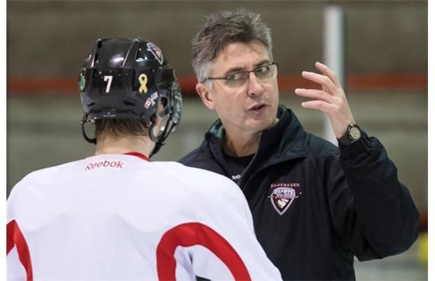 Claude Noel goes over strategy with Ty Ronning during a Giants practice. (Province Files.)