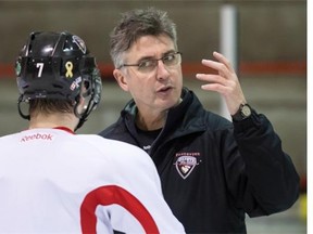 Claude Noel goes over strategy with Ty Ronning during a Giants practice. (Province Files.)