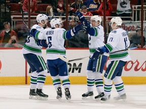 Alexander Edler, Yannick Weber, Henrik Sedin and Radim Vrbata celebrate a third period goal against the Arizona Coyotes at Gila River Arena on March 22, 2015 in Glendale, Arizona.  The Canucks defeated the Coyotes 3-1. (Photo by Norm Hall/NHLI via Getty Images)