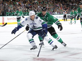 Kevin Bieksa fends off Jamie Benn during a Canucks-Stars tilt in October in Dallas. The Stars have won five straight against Vancouver, including two this season. (Photo by Glenn James/NHLI via Getty Images)