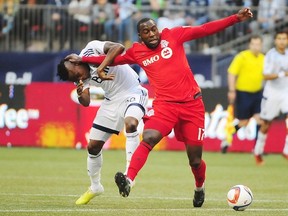 Whitecaps Gershon Koffie battles with Toronto FC's Jozy Altidore. The Caps lost their MLS opener 3-1 at B.C. Place. (Anne-Marie Sorvin-USA TODAY Sports)