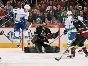 Canucks winger Alex Burrows tries to cause chaos in front of Coyotes goalie Mike Smith on Thursday.  (Photo by Norm Hall/NHLI via Getty Images)