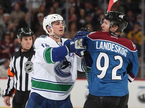 Alex Burrows, tussling here with Gabriel Landeskog of the Colorado Avalanche in a March 27, 2014 game, is expected to be back in the Vancouver line-up tonight after sitting out practice on Wednesday. (Getty Images File.)