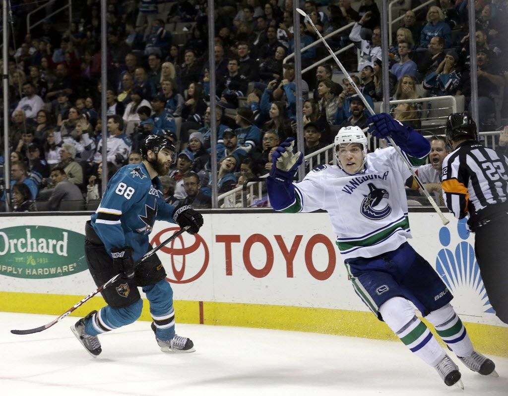 Vancouver Canucks center Bo Horvat, right, celebrates after scoring a goal, in front of San Jose Sharks defenseman Brent Burns (88) during the second period of an NHL hockey game in San Jose, Calif., Saturday, March 7, 2015. (AP Photo/Jeff Chiu)