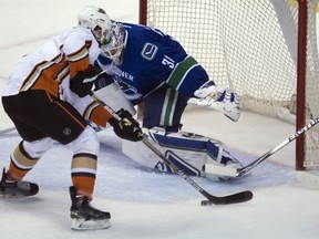 Anaheim Ducks defenceman Cam Fowler (4) tries to get a shot past Vancouver Canucks goalie Eddie Lack (31) during the first period of NHL action in Vancouver, B.C. Monday, March 9, 2015. THE CANADIAN PRESS/Jonathan Hayward