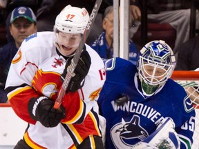 Sven Baertschi battles former Canucks goalie Cory Schneider while a member of the Calgary Flames in 2013. He has been called up to the Canucks a month after being traded from Calgary to play on Vancouver's Utica farm team. (Darryl Dyck, CP files)