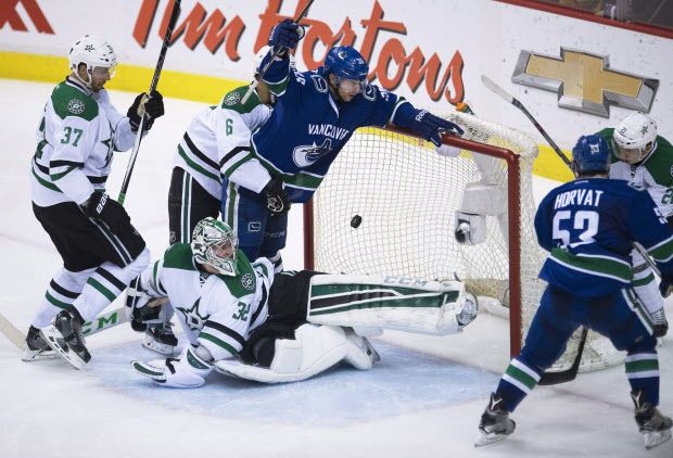Vancouver Canucks' Bo Horvat (53) scores on Dallas Stars goalie Kari Lehtonen (32) as Vancouver Canucks' Jannik Hansen (36) looks on during the second period of NHL action in Vancouver, B.C. Saturday, March. 28, 2015. The goal was later disallowed. THE CANADIAN PRESS/Jonathan Hayward