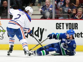 Defenceman Jeff Petry, checking Daniel Sedin here in a past match-up between the Oilers and Canucks, was dealt to Montreal Monday morning.
 (Photo by Jeff Vinnick/NHLI via Getty Images)
