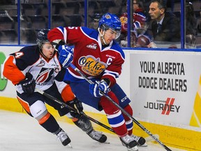 Edmonton Oil Kings defenceman Ashton Sautner, trying to get away from Kamloops Blazers forward Matt Needham here, signed an entry-level contract with the Vancouver Canucks, according to reports. (Photo by )