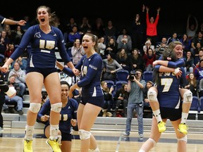 Celebrating the final point and the first CIS national women’s volleyball title in its school’s history are (l to r) Alicia Perrin, Nikki Cornwall, Elizabeth Wendel, Sophie Carpentier (7) and Kristen Moncks. TWU rallied to beat Alberta 3-2 Sunday at the University of Toronto. (Scott Stewart, TWU athletics)