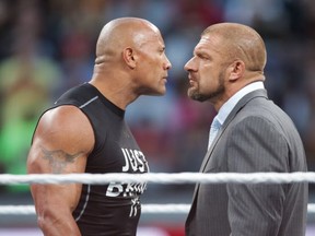Dwayne the Rock Johnson stares off against WWE superstar Triple H at WrestleMania 31 on Sunday, March 29, 2015 in Santa Clara, CA. WrestleMania broke the Levis Stadium attendance record at 76,976 fans from all 50 states and 40 countries. (Don Feria/AP Images for WWE)