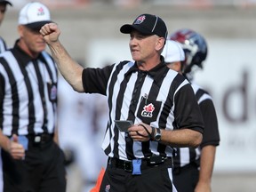 MONTREAL, QUE.: SEPTEMBER 07, 2014 -- Referee kim Murphy signals a penalty during Canadian Football League game between the Montreal Alouettes and Hamilton Tiger Cats in Montreal Sunday September 07, 2014.  (John Mahoney  / THE GAZETTE) ORG XMIT: 50842-1192