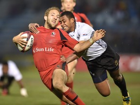 Fiji's Samisoni Viriviri (R) tackles Canada's Sean White (L) during the play-off for the third place at the Tokyo Rugby Sevens in Tokyo on April 5, 2015. Fiji won the match.  (KAZUHIRO NOGI/AFP/Getty Images)