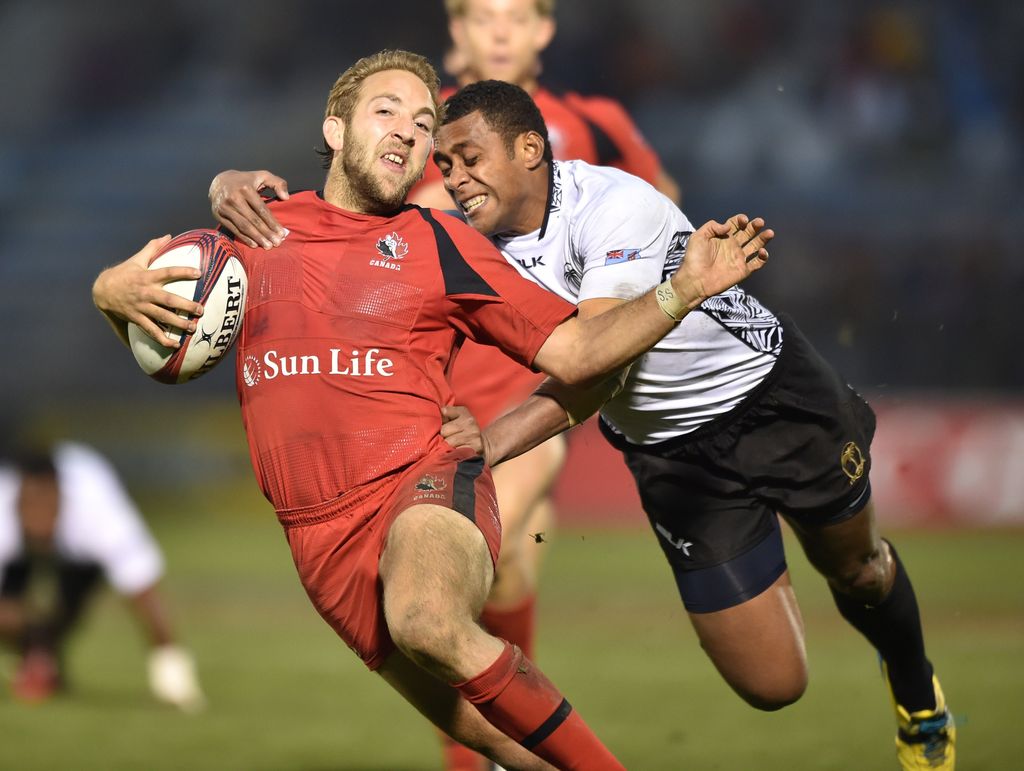 Fiji’s Samisoni Viriviri (right) tackles Canada’s Sean White (left) during the play-off for the third place at the Tokyo Rugby Sevens in Tokyo on April 5, 2015. Fiji won the match.  ( KAZUHIRO NOGI/AFP/Getty Images)