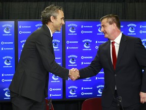 VANCOUVER, BC - MAY 23:  Vancouver Canucks President Trevor Linden (L) shakes hands with Jim Benning as he introduces  him as the team's new General Manager during a press conference at Rogers Arena May 23, 2014 in Vancouver, British Columbia, Canada.   (Photo by Jeff Vinnick/NHLI via Getty Images)