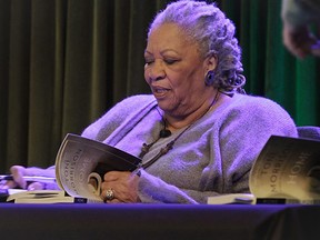 Author Toni Morrison signs copies of her latest book "Home," during Google's online program series, Authors At Google, on Wednesday, Feb. 27, 2013 in New York.  (AP Photo/Bebeto Matthews)