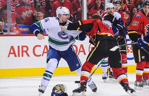 Canucks’ Alex Burrows battles Calgary’s Kris Russell near the end of Game 3 on Sunday. (Getty Images