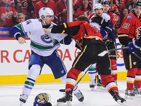 Canucks' Alex Burrows battles Calgary's Kris Russell near the end of Game 3 on Sunday.