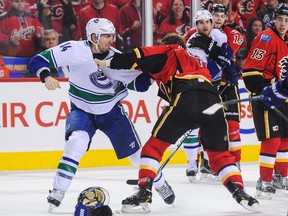 Alex Burrows and Kris Russell square off in the late stages of Game 3 between Vancouver and Calgary Sunday night. (Getty Images.)