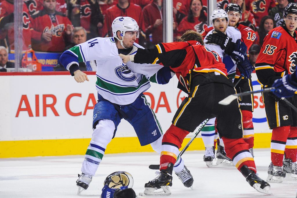 Alex Burrows and Kris Russell square off in the late stages of Game 3 between Vancouver and Calgary Sunday night. (Getty Images)