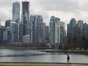 Another unhappy Vancouverite walks the seawall in the shadow of empty condos.