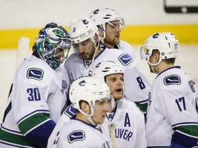 Chris Tanev consoles Ryan Miller after the Game 6 loss to Calgary.